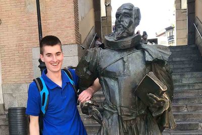 Peter Sabini with Cervantes' statue in Spain